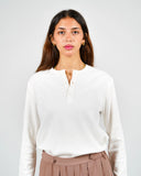 Dorian off-white ribbed long-sleeve Henley shirt, front view on a female model.