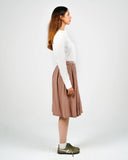 Dorian off-white ribbed long-sleeve Henley shirt, side view on a female model.